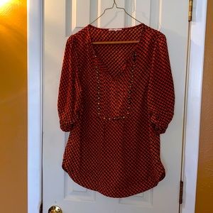 Hawthorn a black and orange blouse with a brss studding